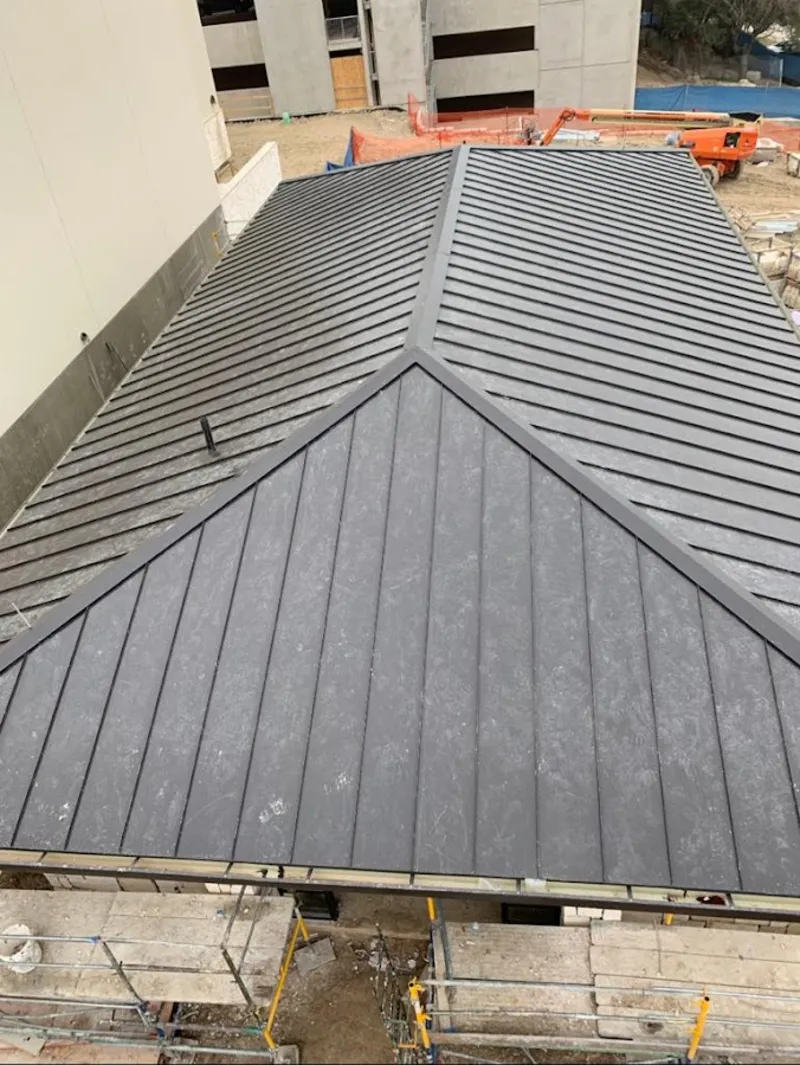 Commercial metal roof construction with crane equipment in Lincolnton