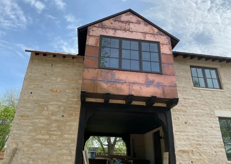 Copper metal panel facade on a stone building for Skylight Installation in Lincolnton